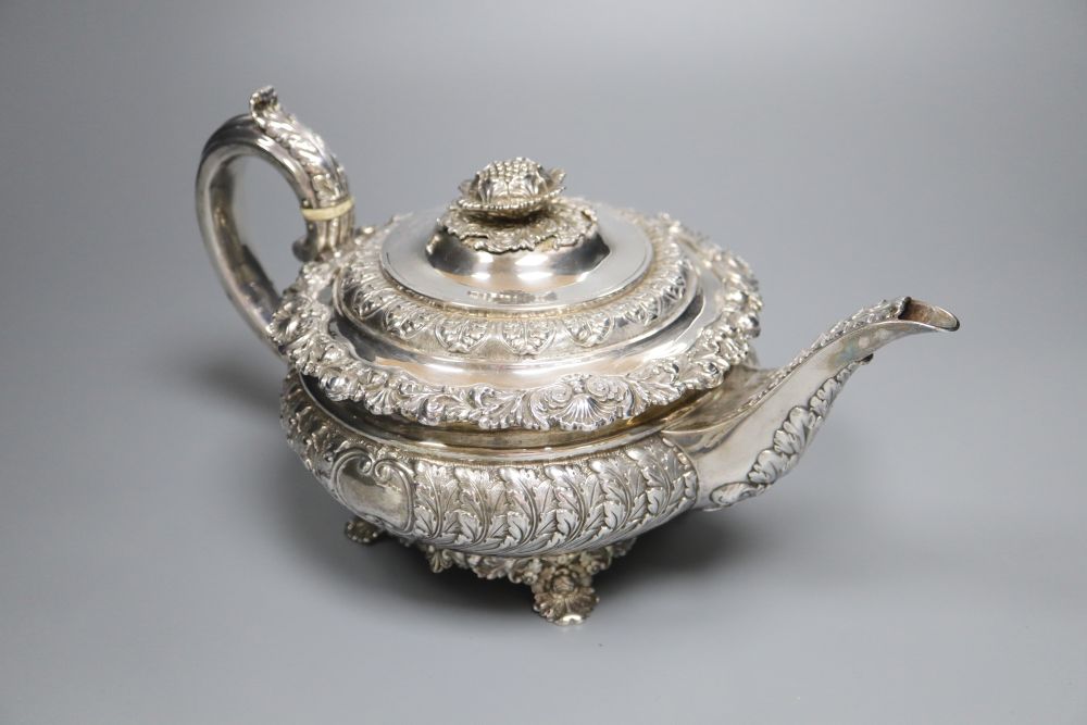A George IV embossed silver squat circular teapot by Emes & Barnard, London, 1822,